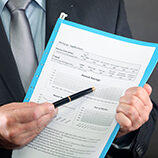 Business man pointing pen to contract
