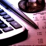 Calculator and pen sitting on top of paperwork